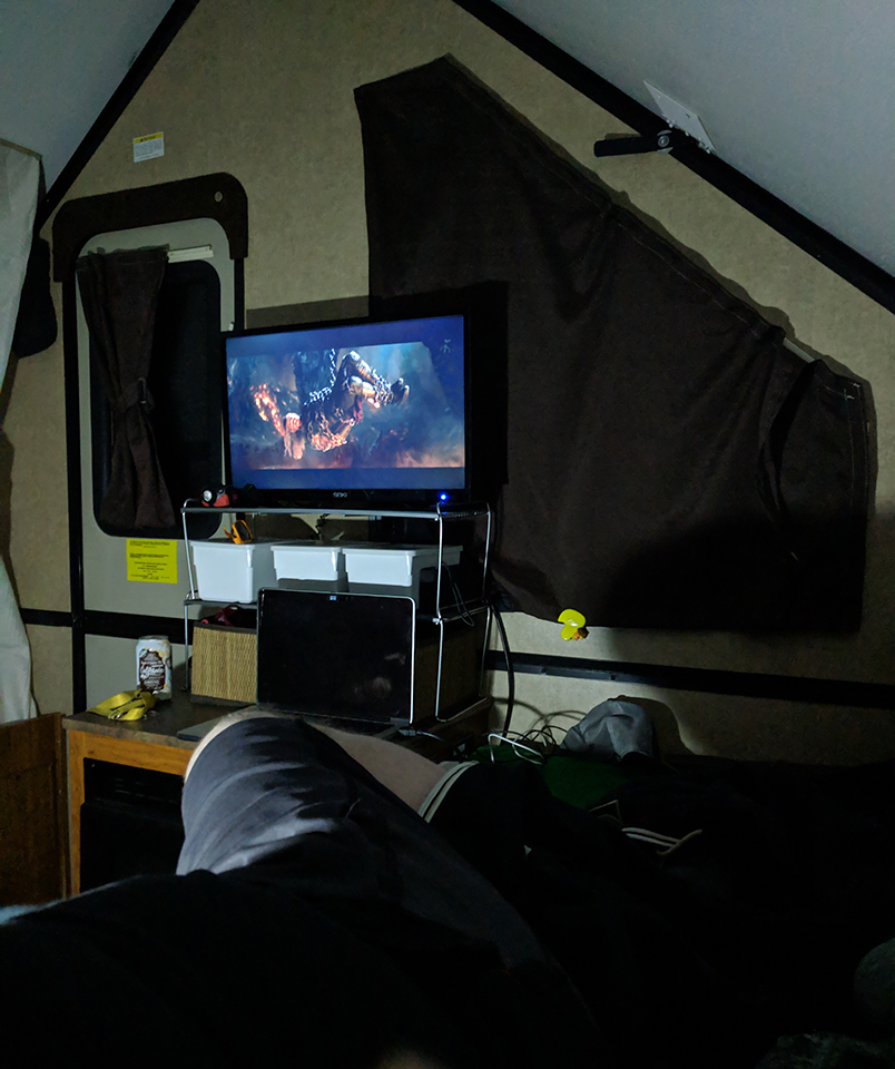 Inside the camper watching a movie on TV