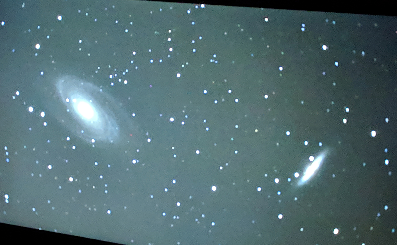 Computer monitor showing a picture of a galaxy